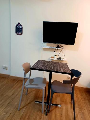 a desk with two chairs and a computer monitor at Saville Cheras Studio Next To Mrt Sri Raya Station in Cheras