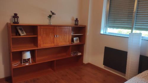 a book shelf in a bedroom with a window at Casa da Bia - AL em Arcos de Valdevez in Arcos de Valdevez