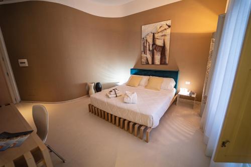 a bedroom with a bed and a painting on the wall at Hotel Cave Del Sole in Matera
