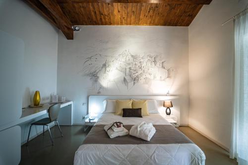 a bedroom with a bed with two towels on it at Hotel Cave Del Sole in Matera