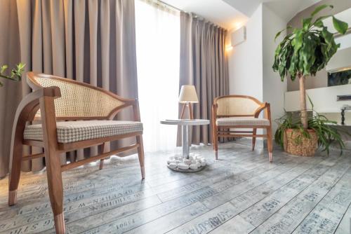 a living room with two chairs and a table at Atik Hotel in Unye