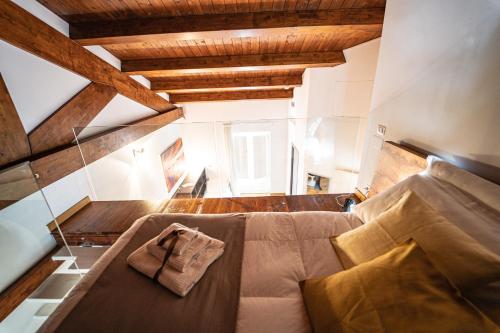 a bedroom with a bed in a room with wooden ceilings at Hotel Cave Del Sole in Matera