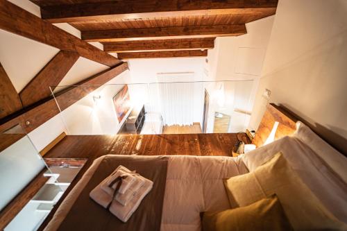 an attic room with a large bed in a room at Hotel Cave Del Sole in Matera