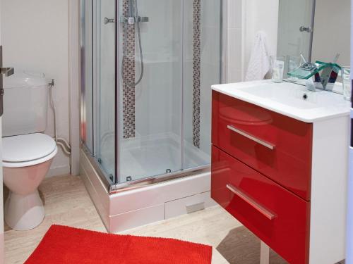 a bathroom with a red sink and a shower at L'aparthoteL LhL in Dijon