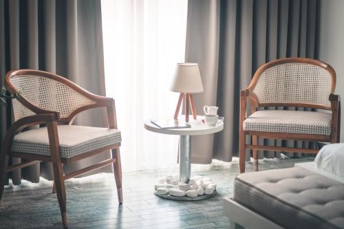 a room with two chairs and a table with a lamp at Atik Hotel in Unye