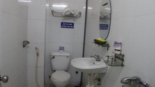 a small bathroom with a toilet and a sink at Nam Phương Hotel Sa Đéc in Sa Ðéc