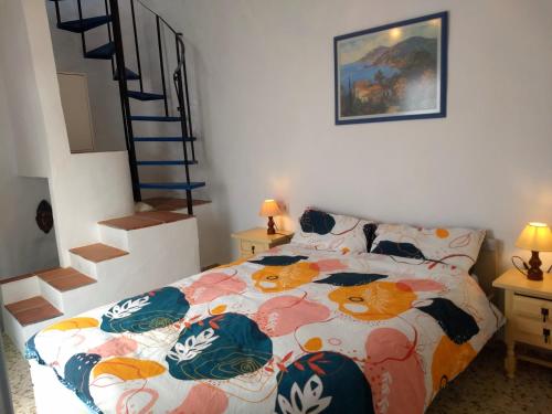 a bedroom with a bed with a cat comforter at Casa TRIGO in Cómpeta