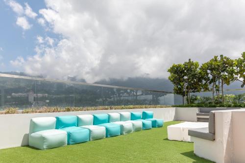 a row of blue and white chairs on a roof at Double Story in the Sky - Genting Windmill Duplex Suite in Genting Highlands
