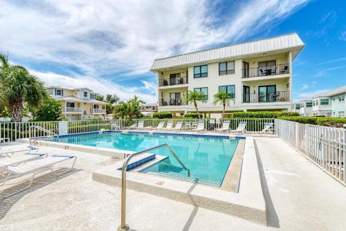 a swimming pool in front of a building at Anna Maria Island Beach Sands 203 in Bradenton Beach
