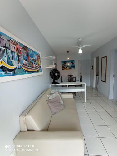 a living room with a couch and a table at Village Hospedagens in Natal