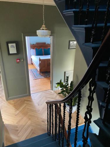a staircase leading to a bedroom with a bed at Ben A'an House in Callander