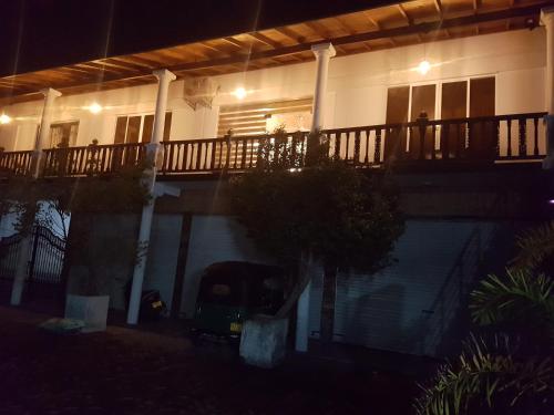 a house with a swimming pool at night at GG Lodge Mirissa in Mirissa