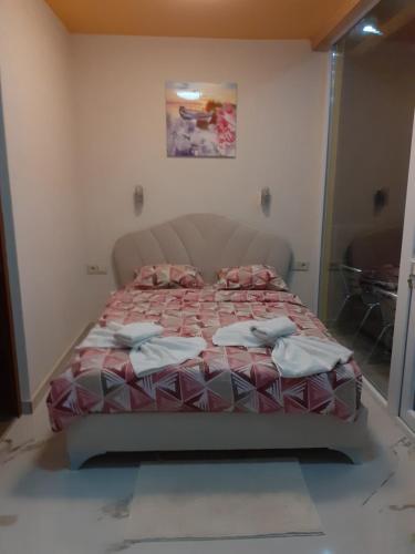 a bedroom with a bed in a room with a window at Safi in Dospat