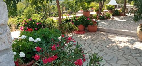a garden with flowers and plants on a patio at Stone House in a quiet landscape, Leonidion in Leonidion