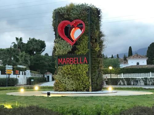 a sign for marbella with a heart on it at Suite Vitbanus in Marbella