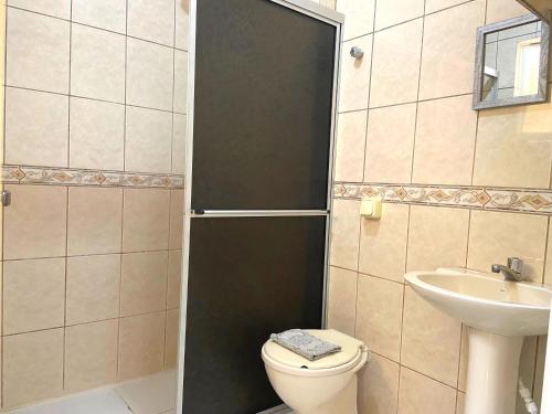 a bathroom with a toilet and a sink at Pousada São Francisco in Florianópolis