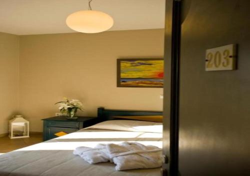 a bedroom with a bed with a towel on it at Princess Of Naxos in Naxos Chora