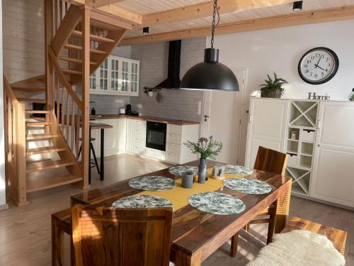 a kitchen and dining room with a wooden table and chairs at Vila Alila in Stará Lesná