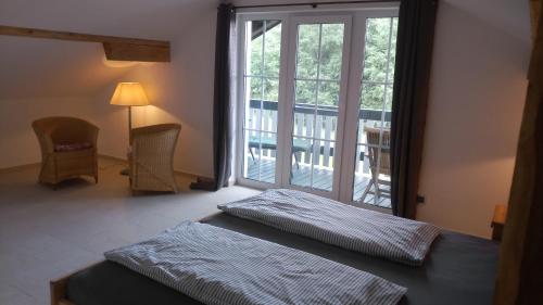 a bedroom with two beds and a large window at Ferienhaus Damberg in Übersee