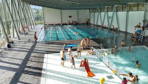a group of people in a swimming pool at Elegant historic apartment Le Mont Joly - 3 bed 2bath view 80m2 in Saint-Gervais-les-Bains