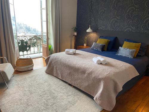 a bedroom with a large bed with towels on it at Elegant historic apartment Le Mont Joly - 3 bed 2bath view 80m2 in Saint-Gervais-les-Bains