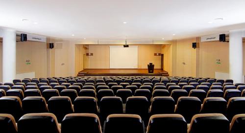 an empty lecture hall with a screen in the background at Monte Baia Uludağ - Full Board Plus in Uludag