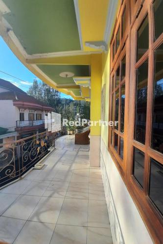 a guest house with a view of the train station at Bromo Indah Lestari Homestay Mitra RedDoorz in Pasuruan