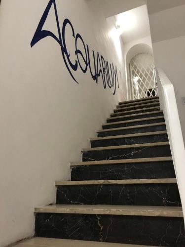 a stairway with a sign on the wall at Acquarium Tropea in Tropea