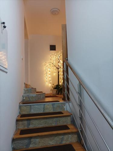 a set of stairs in a house with a chandelier at Apartmani Mladenović in Kijevo