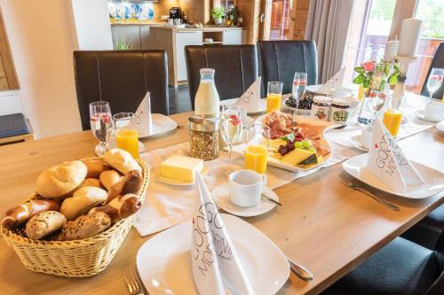 a wooden table with breakfast foods on it at Starmacher Hof in Itter