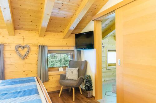 a bedroom with a bed and a chair at Starmacher Hof in Itter