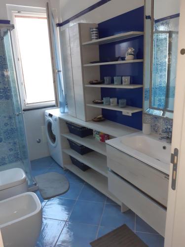 a bathroom with a toilet and a tub and a sink at Chiara's apartment Procida in Procida