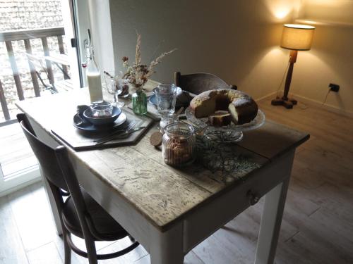 a table with a bowl of food on top of it at Maison de la montagne - Chambres & Relax in Arvier
