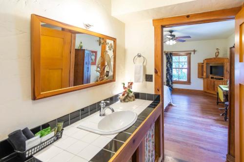 a bathroom with a sink and a mirror at Hibiscus Coffee & Guesthouse in Santa Rosa Beach