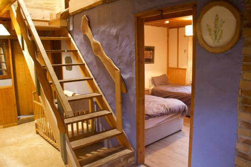 a room with a spiral staircase and a bedroom at Dave's Big House in Kilcar