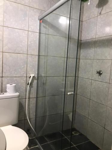 a shower stall in a bathroom with a toilet at Pousada Encanto da Roça in Mucugê