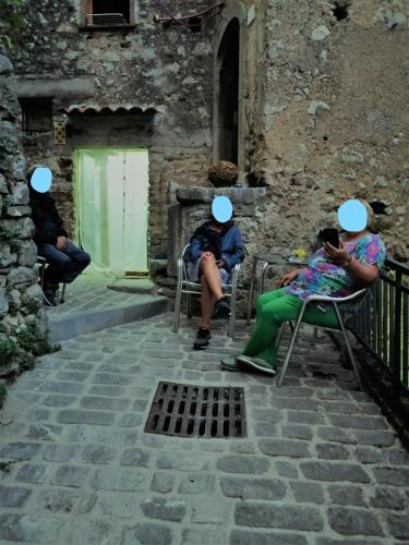 a group of people sitting in chairs in front of a building at Tre metr sopra il cielo '' GiraSoli'' in Felitto