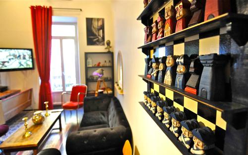 a room with a wall filled with lots of shoes at DUPLEX 5 chambres Clim WIFI SAUNA Cannes in Cannes