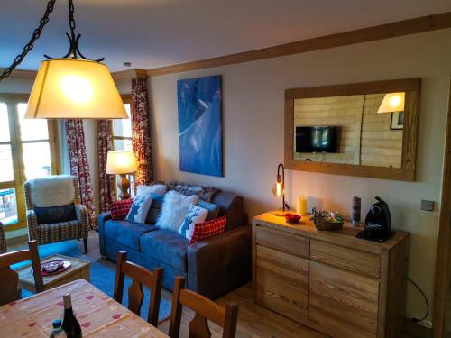 a living room with a couch and a table at Hameau du Glacier 524 - Arc 1950 le village in Bourg-Saint-Maurice