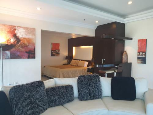 a living room with a couch and a bed at Costa Del Sol Hotel by Arabian Link in Kuwait