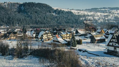 a small town covered in snow with houses at Dom Wypoczynkowy u Niedzielskich in Białka Tatrzanska