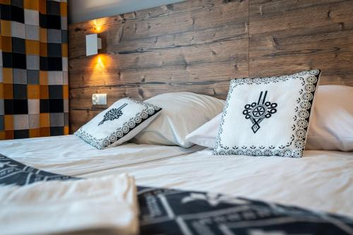 a bed with two pillows on top of it at Dom Wypoczynkowy u Niedzielskich in Białka Tatrzanska