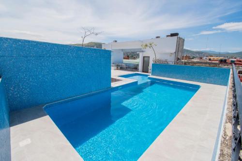 a pool with blue tiles on a building at Suites de La Parra in Oaxaca City
