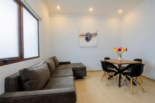 a living room with a couch and a table at Suites de La Parra in Oaxaca City