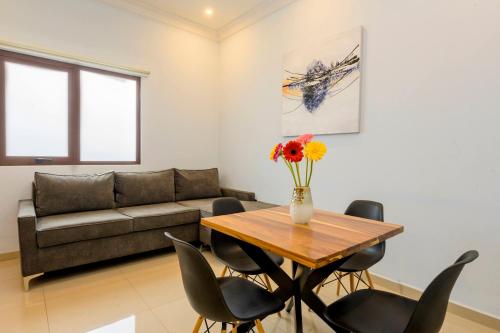 a living room with a table and a couch at Suites de La Parra in Oaxaca City