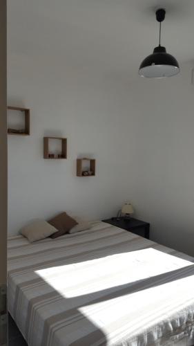 a white bedroom with a large bed in a room at villa l atlantide in Vieux-Boucau-les-Bains
