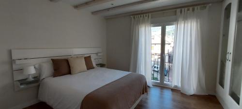 a bedroom with a bed and a large window at Casa la Fuentecilla in El Arenal