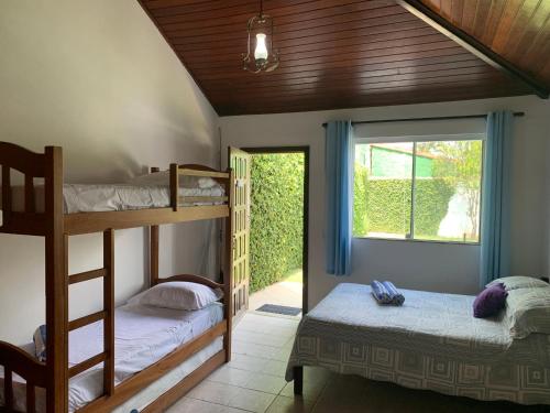 a bedroom with two bunk beds and a window at Kitchenette near the Beach/including Breakfast in Búzios