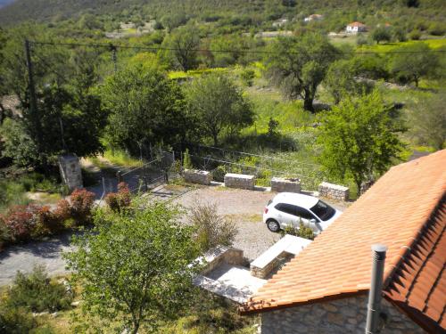 a white car parked in a parking lot at Amygdalia, a Stone House in a quiet landscape in Leonidion