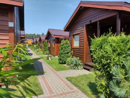 a row of wooden cabins in a resort at Zielony Gaj in Wicie